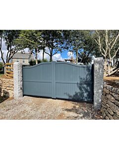 Anthracite grey liberty metal driveway gate outside house with stone fence either side